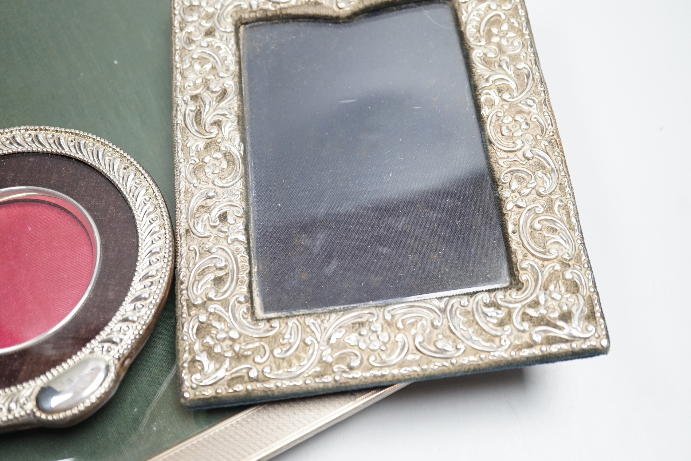 A large 1920's engine turned silver mounted rectangular photograph frame, Birmingham, 1928, 33.2cm and two other silver mounted photograph frames including circular.